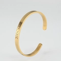 Detail view of gold open bangle featuring precision engraved moon phase patterns - Hollow Gold Color
