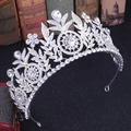 Detailed close-up of a silver bridal tiara with floral rhinestone patterns and crystals - Silver White Rhinestone