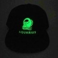 Glow-in-the-dark Aquarius zodiac sign on a black baseball cap in nighttime environment - Adjustable / Aquarius
