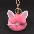 Close-up of pink fluffy cat keychain with glitter ears and golden metal lobster clasp - Deep Pink