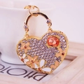 Charming heart keychain with orange gemstone and enamel flowers on a gold-plated frame - Peach