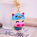 Colorful cartoon pig keychain in metal with blue rhinestones and gold-tone chain - Blue