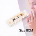 Detail shot of a 8cm gold pearl hair clip with polished beads on a fashion magazine - Square Pearl BB Clip