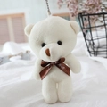 Close-up of small white teddy bear plush keychain with a brown Love ribbon and metal chain - Off White