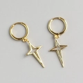 Macro detail of gold North Star hoop earrings with hollow cross star charms - 925 Silver / Gold