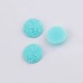 Close-up of 10mm light blue druzy resin cabochons showing faceted and smooth textures - Light Blue (25)