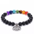 Black lava rock chakra bracelet featuring seven colored stones and a silver lotus pendant - Lotus Chakra Design