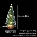 Close-up of a 15cm mini LED Christmas tree with snow flocking and a rustic wood base - Warm Light Style / 15CM