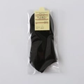 Solid black low-cut cotton liner socks with star dot pattern in retail packaging - One Size / Black