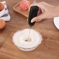 Handheld black electric milk frother and egg beater used in a kitchen setting - Boxed Black