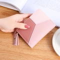 Short bi-fold pink patchwork wallet for women featuring fringe and rabbit charm - Pink