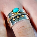 Macro shot of a vintage turquoise ring with two-tone silver and gold details on finger - US 6 / Ancient Silver Turquoise