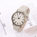 Fashion beige canvas strap watch with bronze case and roman numeral dial on paper background - Beige