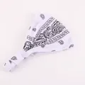 Detail of white paisley cotton headband showing elastic pleated design and soft texture - White
