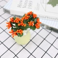 Artificial orange berry stem with green leaves in a small vase for home desktop decor - Orange