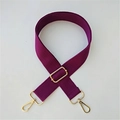 Macro detail of high-quality adjustable purple nylon bag strap with premium gold hardware - Purple