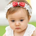 Baby girl white lace headband featuring a vibrant red and white polka dot satin bow - Red Polka Dot Bow