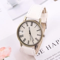 Primo piano di orologio vintage al quarzo in bronzo con numeri romani e pelle bianca - Bianco