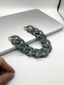 Detailed view of matte gray acrylic bag chain with gold circular metal clasps on laptop - 30cm / Green