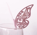 Close-up of pink laser-cut hollow butterfly card used as a wedding glass decoration - Light Purple