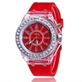 Detailed view of red quartz watch featuring a clear plastic case and rhinestone bezel - Red