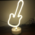 Middle finger gesture LED neon light with warm yellow glow and white circular base - Guitar (Warm White) With Base