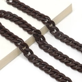 Macro shot of dark brown acrylic thick chain links placed on white decorative books - Dark Brown