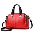 Fashionable red soft leather handbag for women with black straps and silver hardware - Red