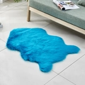 Irregular blue faux fur rug in a cozy living room setting with a wooden sofa - Irregular Dark Blue