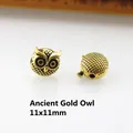 Detailed view of 11x11mm antique gold owl charm beads with intricate relief for DIY jewelry - Antique Gold Owl