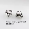 Detail of antique silver leopard head jewelry beads with embossed textures, 11x12mm size - Antique Silver Leopard Head