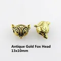 Antique gold fox head bead 13x10mm for DIY jewelry making showing vintage texture - Antique Gold Fox Head