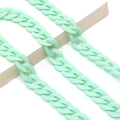 Close-up of mint green acrylic chain links on a white book for fashion styling - Mint Green