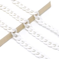 Macro detail of white acrylic chunky chain links arranged on a book for accessories - Pure White