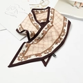 Beige skinny scarf with brown chain print and GG pattern tied on a magazine - Chain Grid Khaki