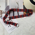 Detail of red and black checkered nylon canvas belt with silver double D-ring buckle - Red