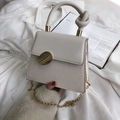 Cream white crossbody bag with unique twisted handle and gold circular metal buckle - White
