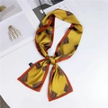 Ginger yellow silk scarf with orange borders and brown patterns in a knotted style - Tassel Print Yellow