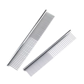 Close-up of dual stainless steel pet grooming combs with fine and coarse rounded teeth - Silver
