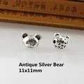 Macro detail of 11x11mm antique silver bear beads with hollow design for DIY jewelry - Antique Silver Bear
