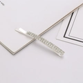 Detail of silver bobby pin featuring double-row crystal rhinestones on polished metal - White Zirconia Silver