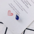 Detail of blue teardrop crystal pendant with gold trim on a white card background - Royal Blue