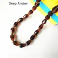 Close-up of dark amber faceted teardrop glass beads with precise cut surfaces for DIY jewelry - 4*6mm / Dark Amber
