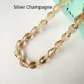 Detailed macro shot of faceted silver champagne waterdrop glass beads for DIY jewelry - 4*6mm / Silver Champagne