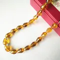 Macro shot of faceted tiger amber teardrop crystal beads for DIY jewelry making - 4*6mm / Medium Amber