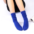 Detailed close-up of blue slouch socks with knitted cotton texture on model - One Size / Sapphire Blue