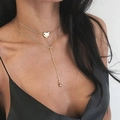 Goldene mehrlagige Halskette mit Herzanhänger und Y-Kette an einem professionellen Model - Gold