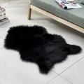 Irregular black faux fur rug for living room displayed on white tile floor - Irregular Black