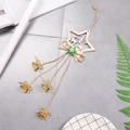 Wooden star Christmas ornament with deer silhouette, green leaves and small gold bells - Double Star Wooden Pendant