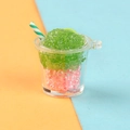 Macro detail of miniature resin smoothie cup charm with pink pearls and green ice - Green